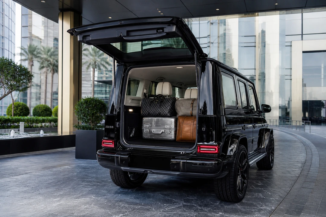 Mercedes-Benz G63 Facelift open hatch with luggage at a Downtown hotel for luxury SUV rental Dubai packing
