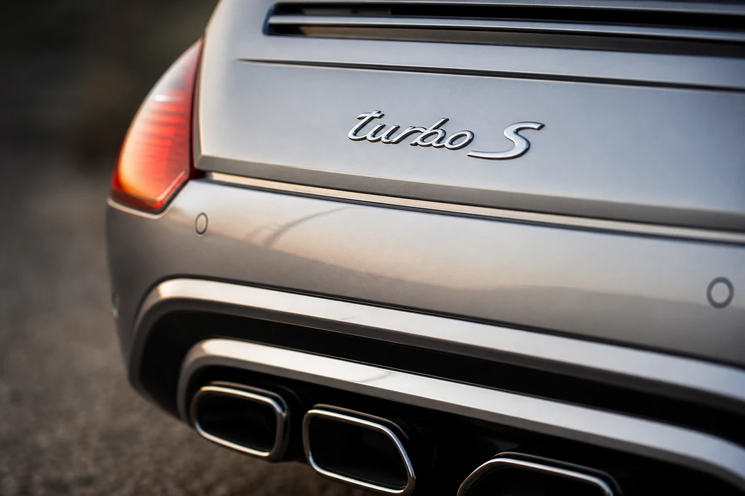 Porsche 911 Turbo S rear badge and dual exhaust detail for flagship 911 character in Dubai