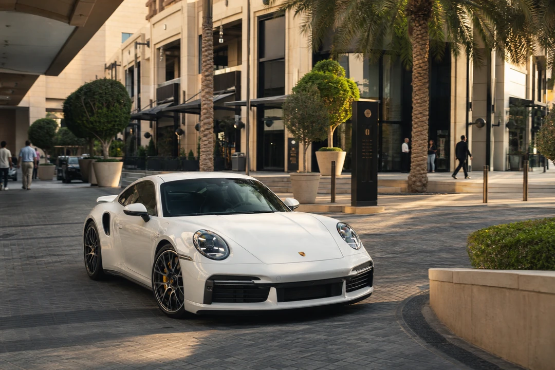 Porsche 911 Turbo S at City Walk Dubai valet in afternoon light for luxury car comparison Dubai usable days