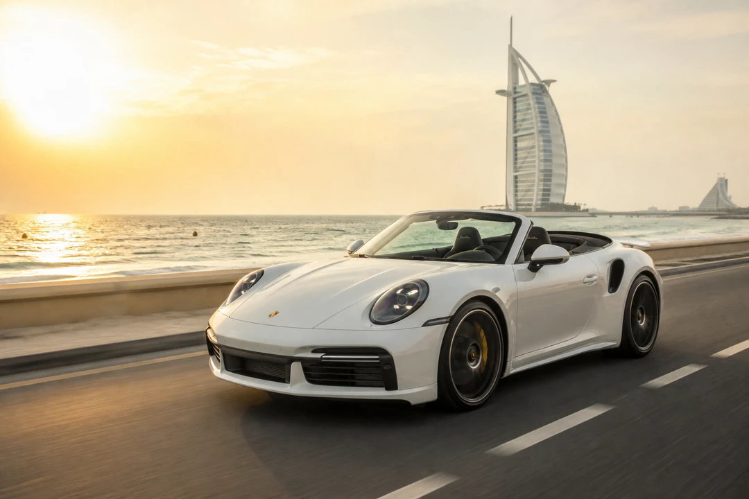 Porsche 911 Turbo S Cabriolet on Jumeirah Beach Road at golden hour for exotic car rental Dubai open-roof loops