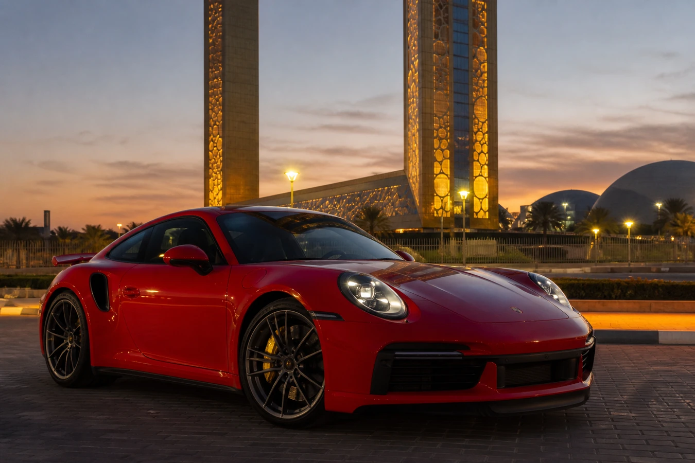 Porsche rental Dubai guide hero with a 911 Turbo S at Dubai Frame at dusk