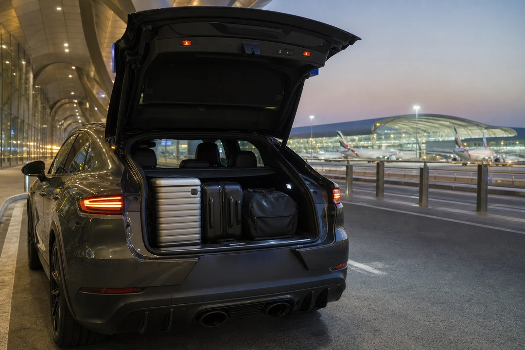 Porsche Cayenne Turbo GT boot with roller cases at Dubai Airport for luxury car rental Dubai packing