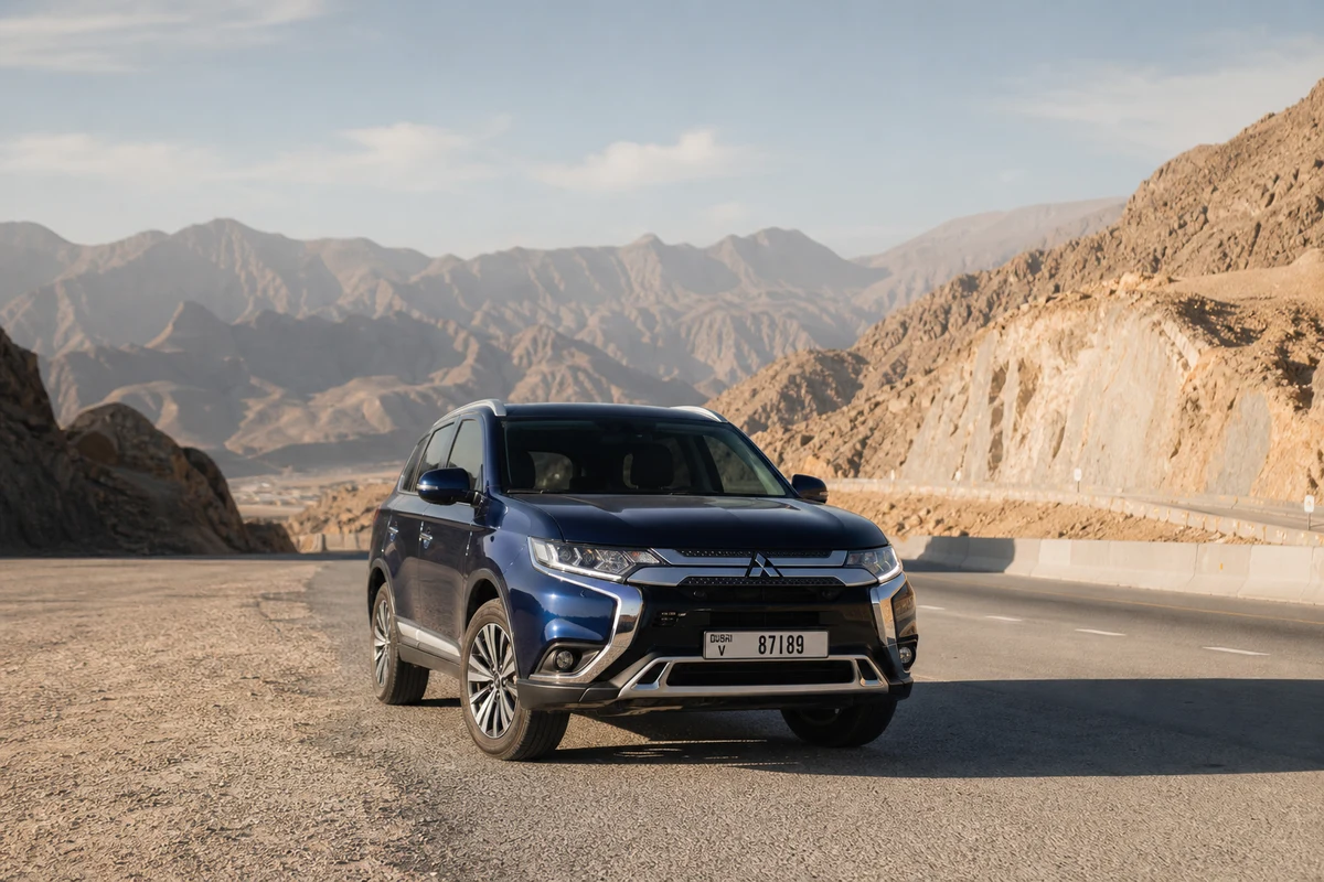 Luxury rental SUV on UAE highway heading east toward Oman border crossing route