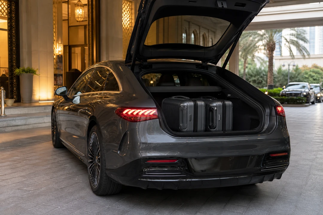 Mercedes EQS boot with roller cases at a Dubai hotel kerb for luxury car hire Dubai packing