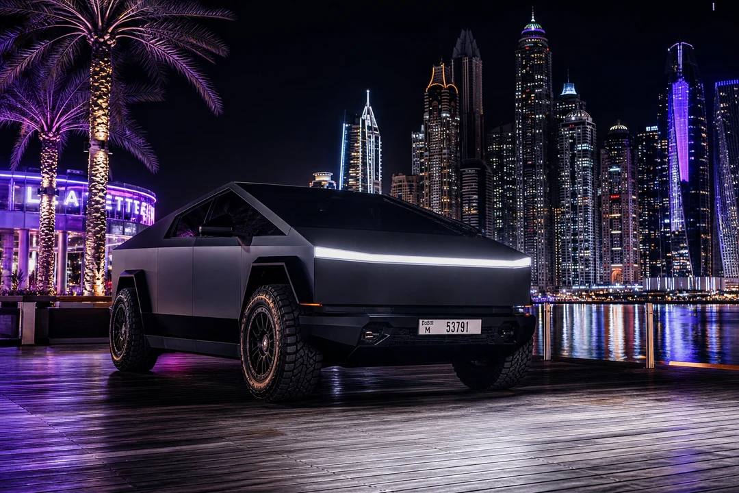 Tesla Cyberbeast on Palm Jumeirah boardwalk at night with Dubai Marina skyline reflected in the water