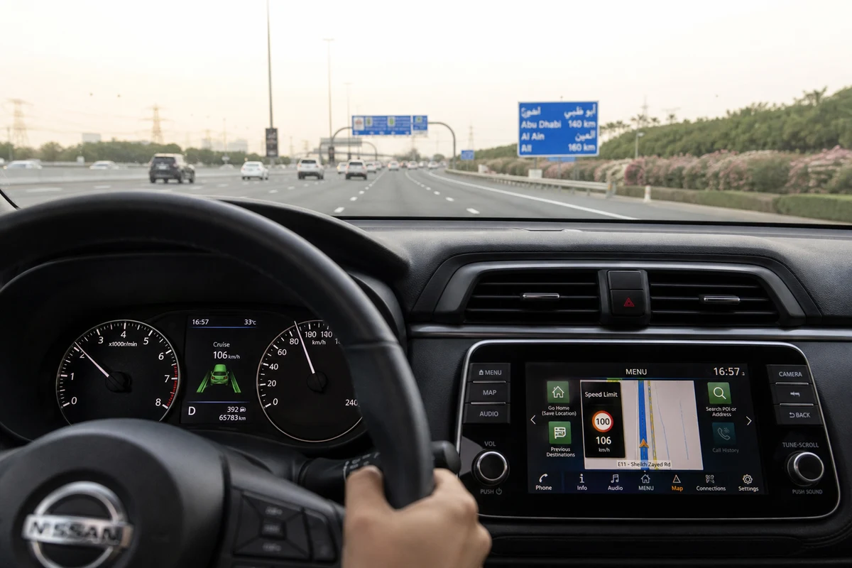 Rental driver checking posted speed limit and navigation overlay in Dubai