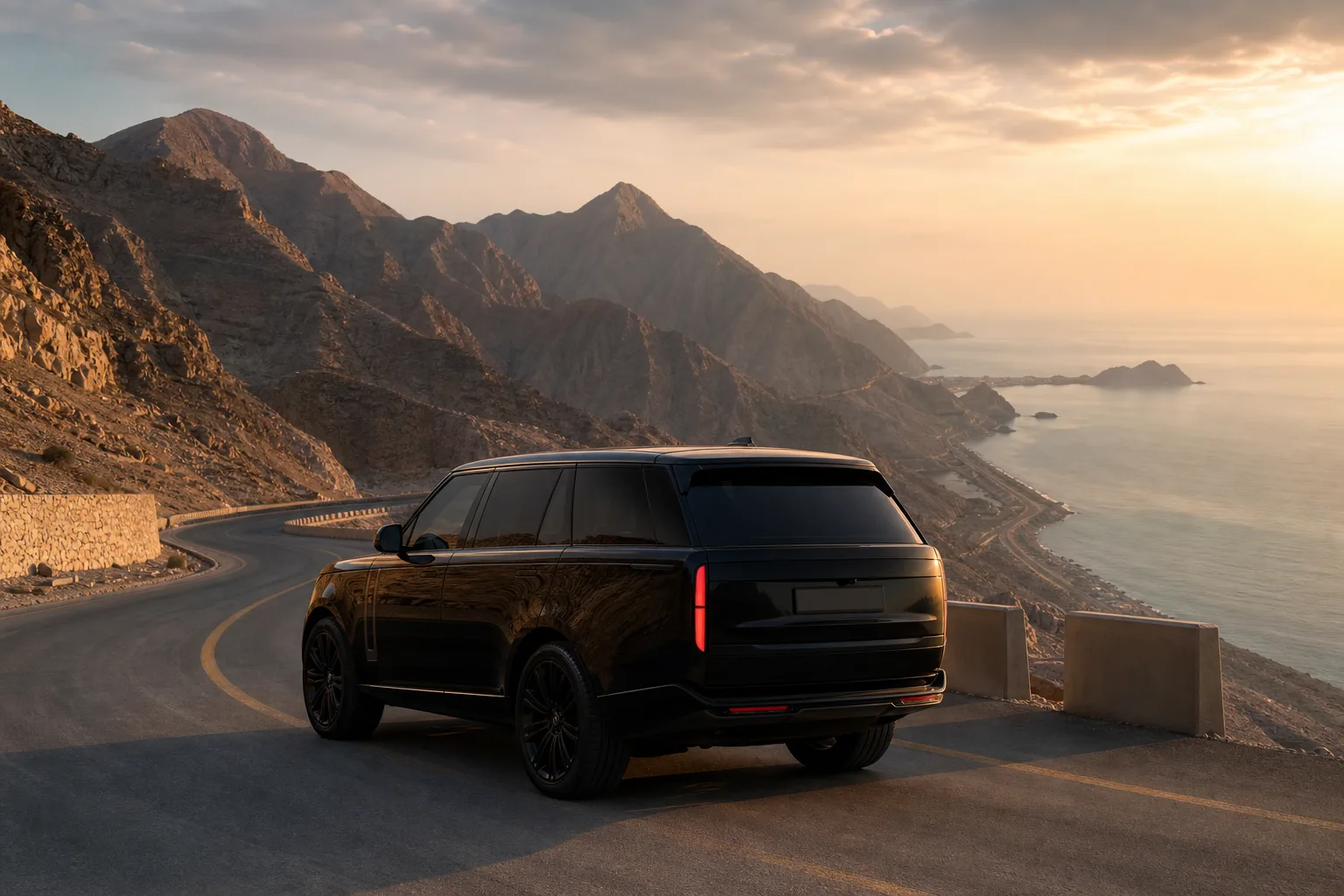 Range Rover on Ras Al Khaimah mountain coastal road with Hajar peaks